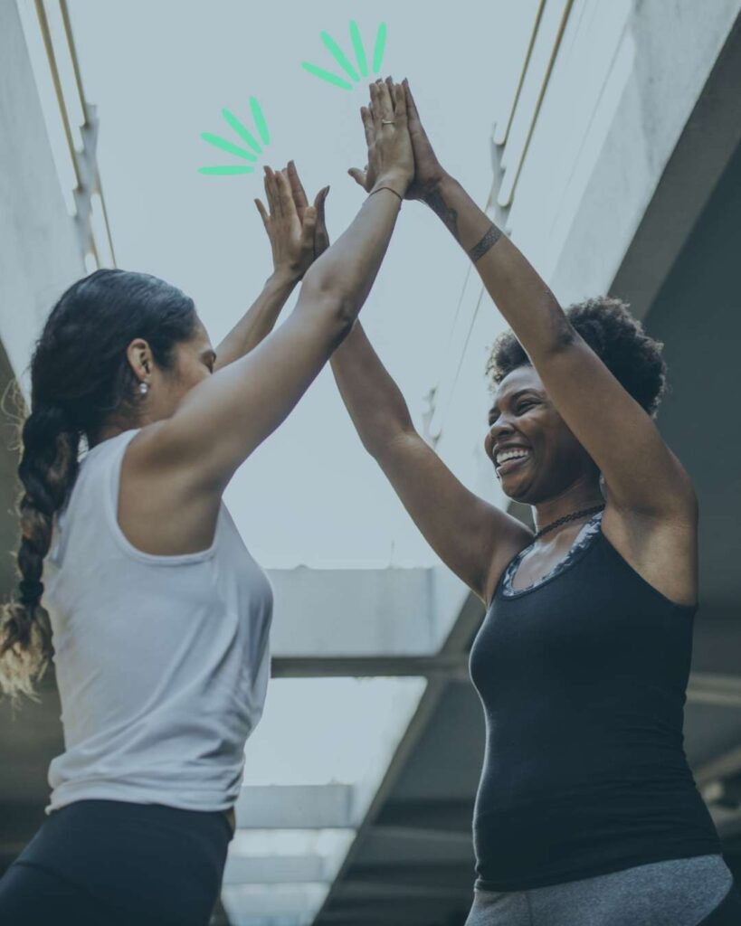 two women high fiving; happy and supported, exactly how we want people who connect with CWS services to feel