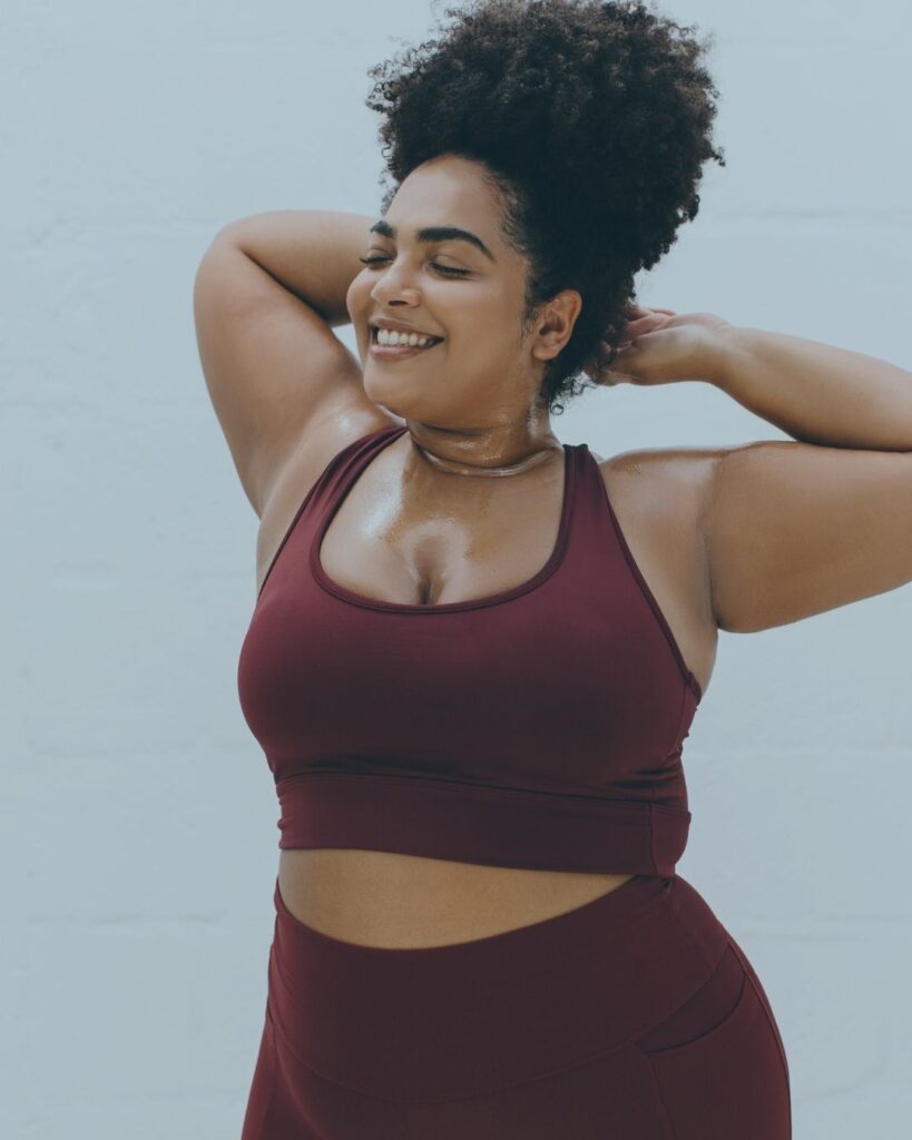 curvy woman smiles reflectively and peacefully